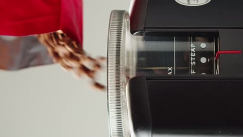 Electric Coffee Grinder Preparing to Grind Coffee in Shop Barista Making Specialty Drink