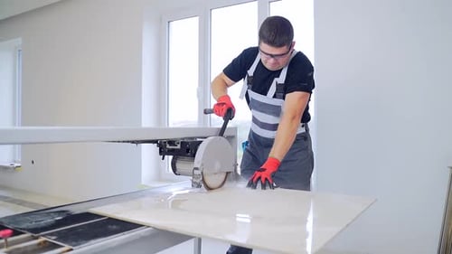 Man Cutting Tile With Wet Saw
