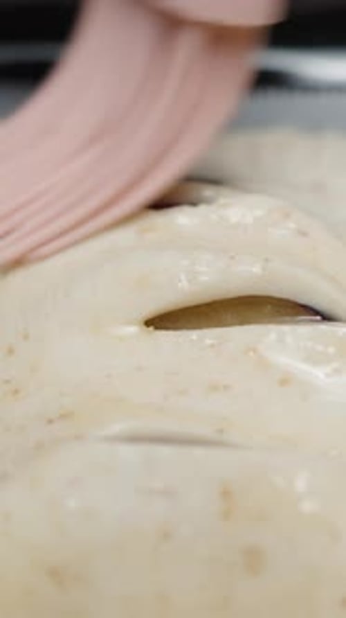 Before frying, the cook greases plum pies with a silicone brush. Egg mixture. Vertical video Social