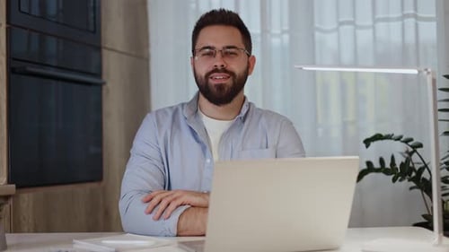 Smiling Man Working from Home at Desk