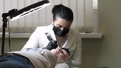 Beautician Provides Facial Cosmetic Procedure to Client