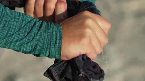 Wringing Hands Wet Shirt Person Squeezing Water From Plaid Fabric Outdoors