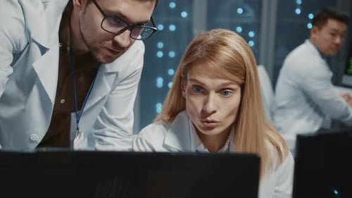 Team of scientists working in server room