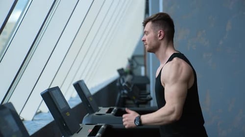Man running on treadmill in gym