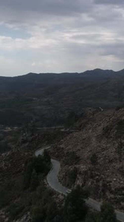 Vertical Video of Car Driving in Mountain Road Aerial View