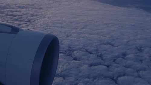 Airplane flying above the clouds city