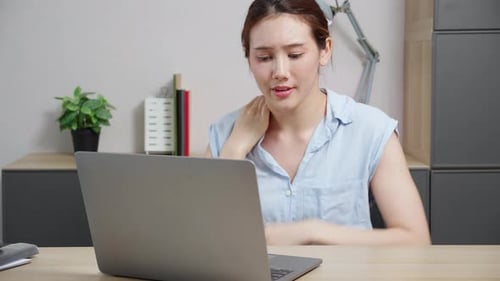 Young caucasian business woman working on laptop computer in office while pain muscle neck.