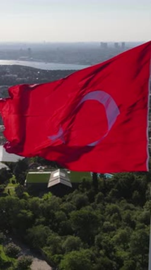 Aerial of a Waving Flag in Urban Nature