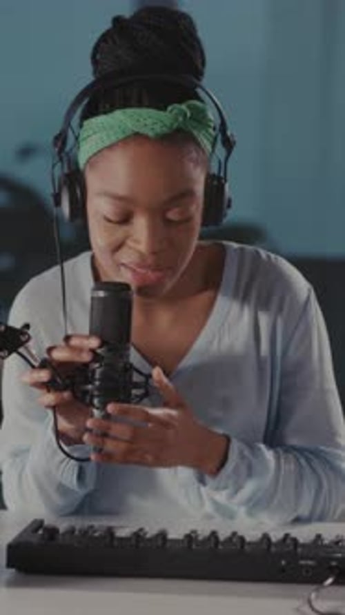 Woman Plays Keyboard and Sings into Microphone