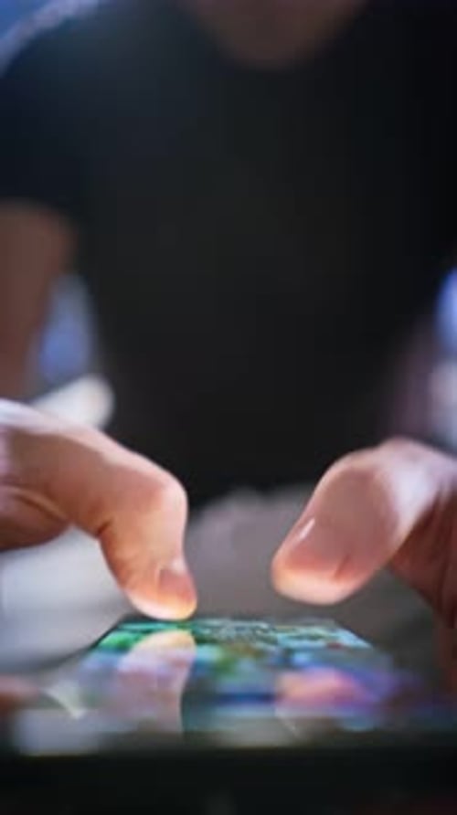 A Closeup of Male Hands Interacting with a Smartphone