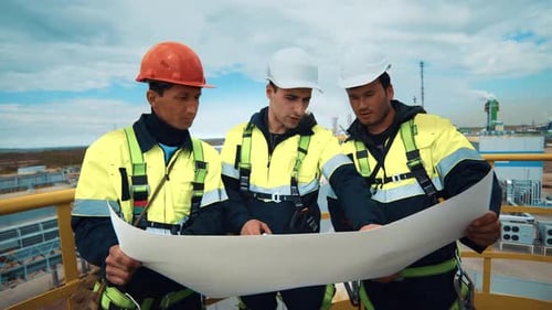 Team of Industrial Male Builder Discuss Plant Factory Engineering Development Use Plan Blueprint