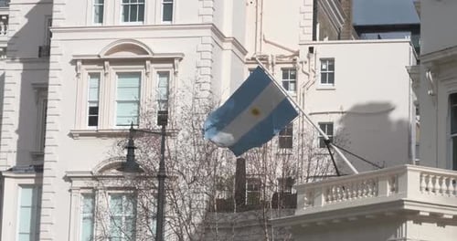 Argentinian Flag Waving in Front of Building