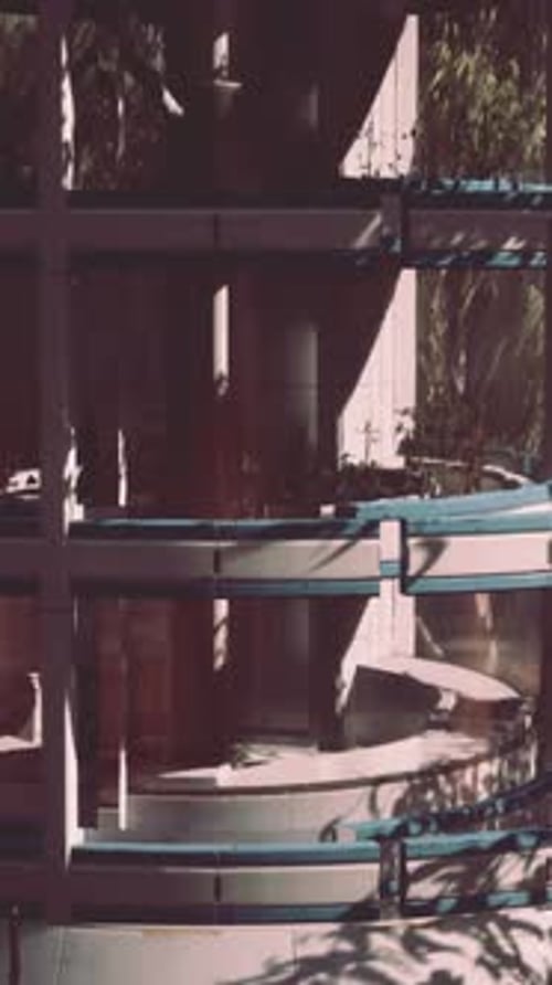 A Futuristic Glass Greenhouse Surrounded By a Serene Forest Landscape