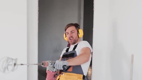 Construction Worker Singing and Acting Silly with Drill