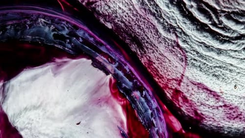 Colorful shot of liquids mixing, forming abstract textures and vivid contrast