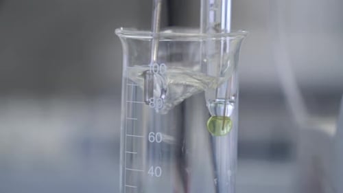 Water boiled in test tube. Transparent liquid in test-tube.