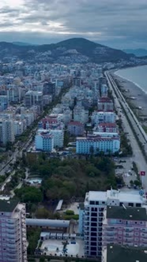 Vertical Video Airborne Tour Over a Picturesque Mediterranean Coastal City with Endless Sea Views