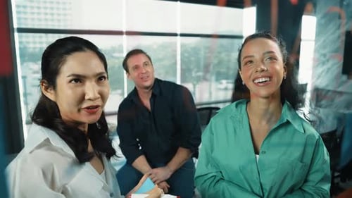 Smiling Colleagues Brainstorming Together Using Sticky Notes on Glass