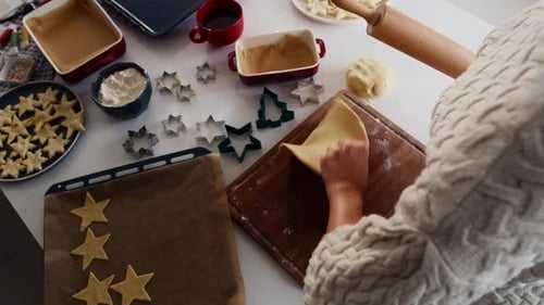 Woman Rolls Dough for Star and Tree Cookies