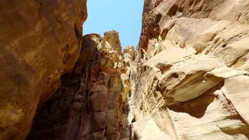 The Majestic Canyon Walls Stand Tall Beneath a Clear and Beautiful Blue Sky Above Action