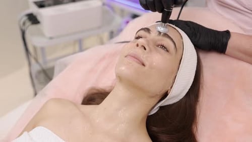 Woman Receiving Facial Treatment at Clinic
