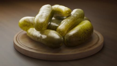 Rotating Fresh Pickles on Wooden Plate