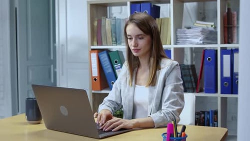 Attractive Young Woman Working in the Office Typing on Laptop Keyboard Positive Business Girl Using