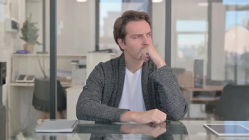 Brainstorming Middle Aged Man Thinking while Sitting in Office