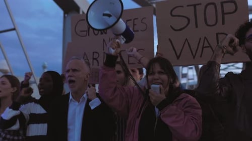 People Protesting and Raising Fists in Urban Setting