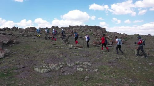 Aerial View Of A Group Of Hikers Climbing The Hill