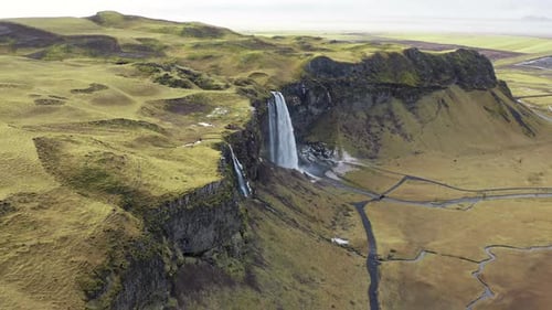 Breathtaking Aerial View of Waterfall in Green Landscape