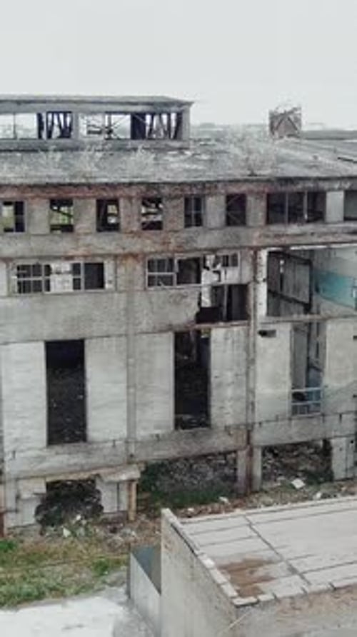 Aerial view of an old factory ruin and broken windows. Old industrial building for demolition.