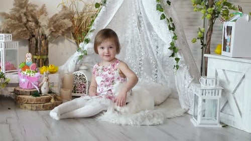 Little Girl Petting White Rabbit at Easter