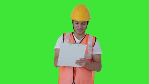 Happy Indian construction labour writing notes Green screen