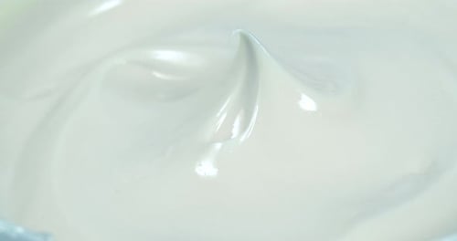 Close Up Shot of Natural Cosmetics Cream with Rotate Effect. Macro White Smooth Facial Cream
