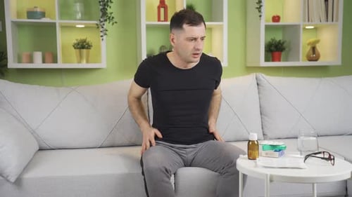 The man with a panic attack is overwhelmed at home.