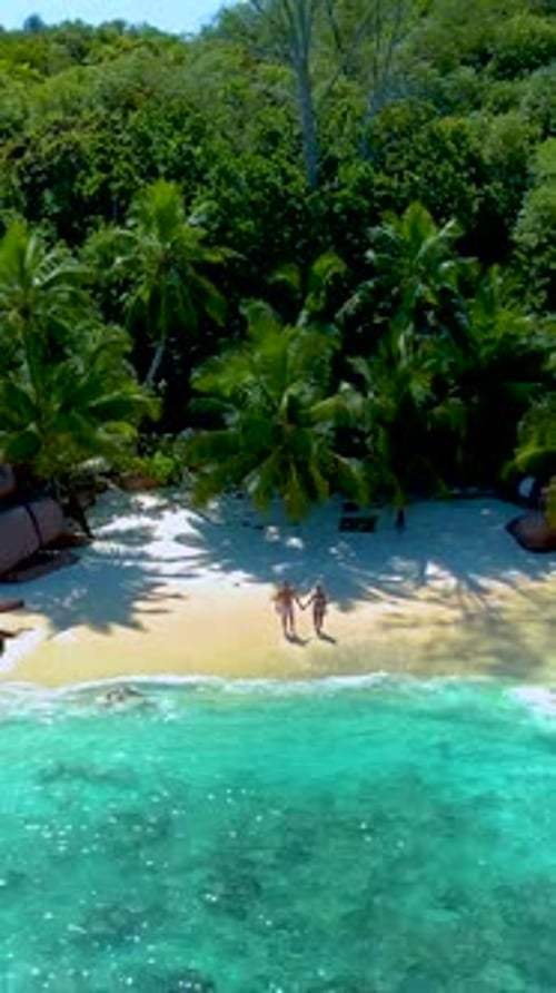 Couple Men and Women on the Beach of Anse Lazio Beach Praslin Island Seychelles Anse Petite Beach