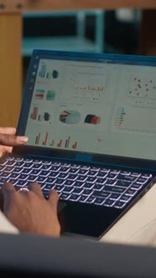 Vertical Video African American Freelancer Working From Home Using Financial Graphs