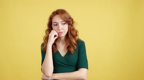 Woman Ponders on Yellow Background