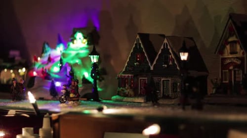 Snowy Miniature Christmas Village with a Rotating Ice Rink and Colorful Lights! Wide Shot!