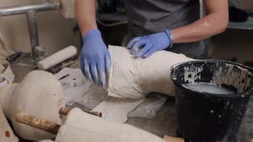Medical Professional Works on a Cast Indoors