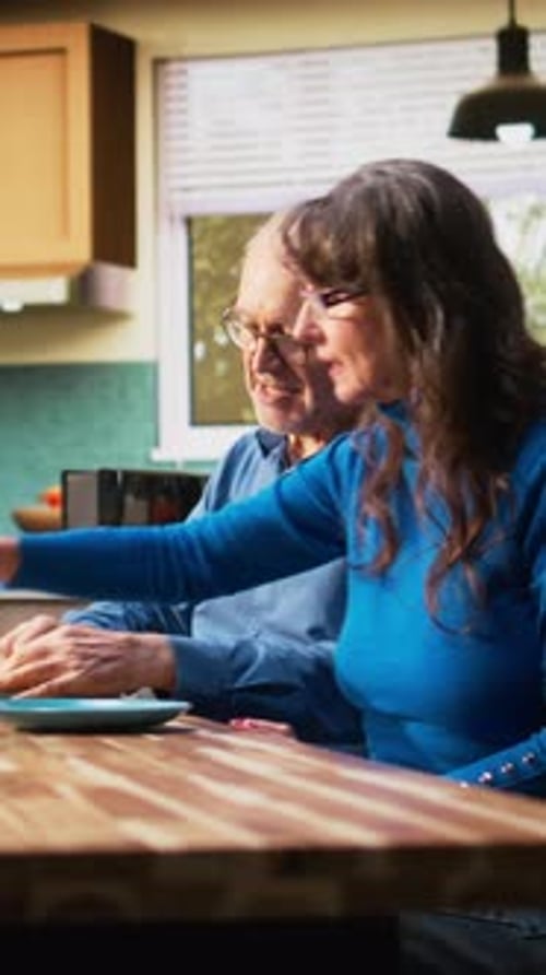 Senior Couple Enjoying Breakfast Together in the Kitchen