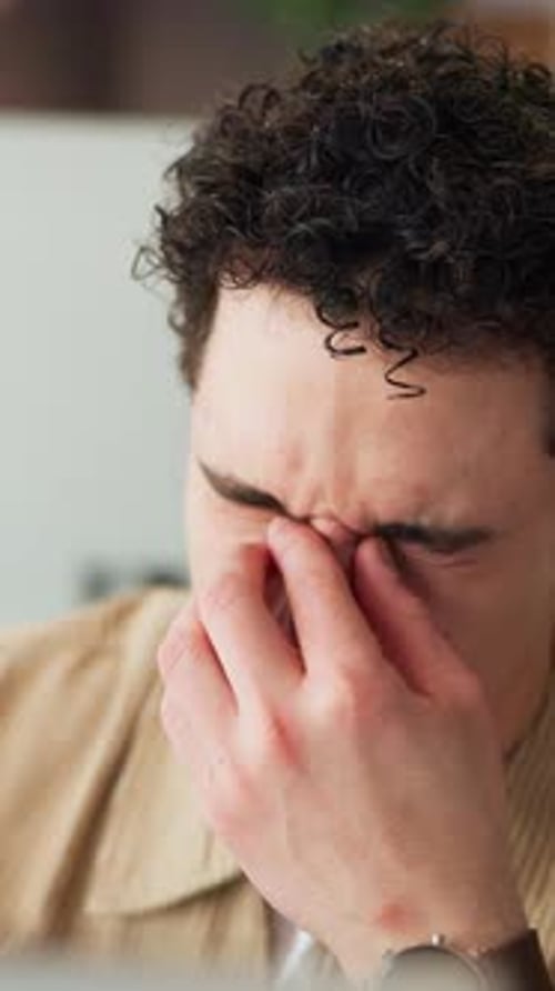 Headache, eye strain or man in office with burnout from online article, blog report or editing