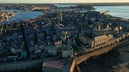 Panoramic drone movement from the seaside Intra Muros at beautiful sunset, Saint-Malo, France.
