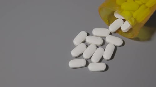 prescription pills pill bottle on neutral gray table