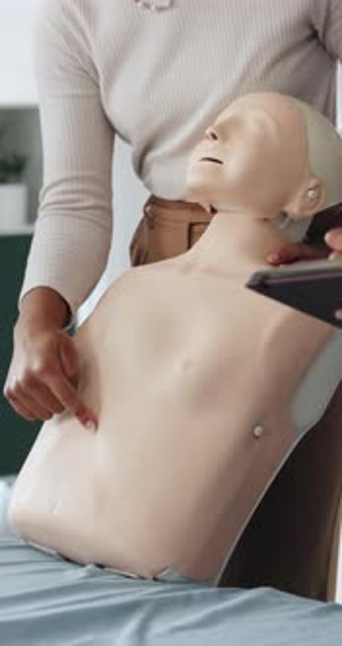 Woman Practicing Medical Procedures on a Clinical Training Mannequin