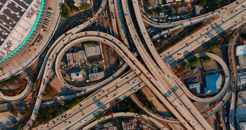 Los Angeles interchange with numerous cars moving by.