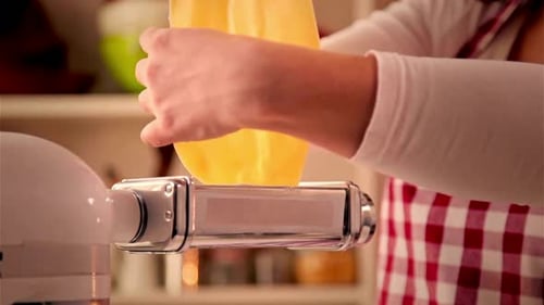 Woman Making Fresh Pasta Dough with Pasta Machine