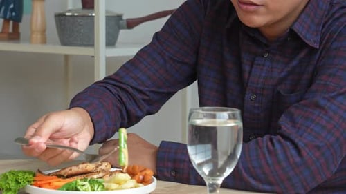 Man Eating Healthy Chicken and Vegetable Meal