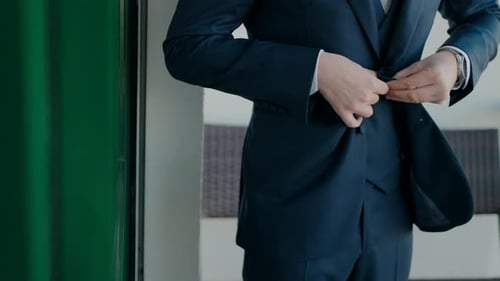 Man in Suit Buttoning Up His Jacket